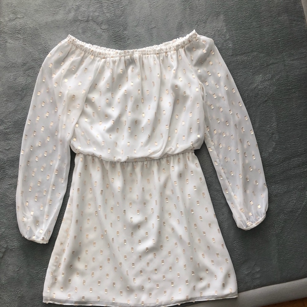 White off the shoulder dress with gold detail.
